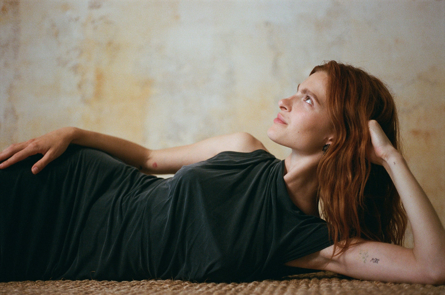 Woman in a flowing dress from SS26 COLLECTION, showcasing feminine minimal aesthetic and effortless style.