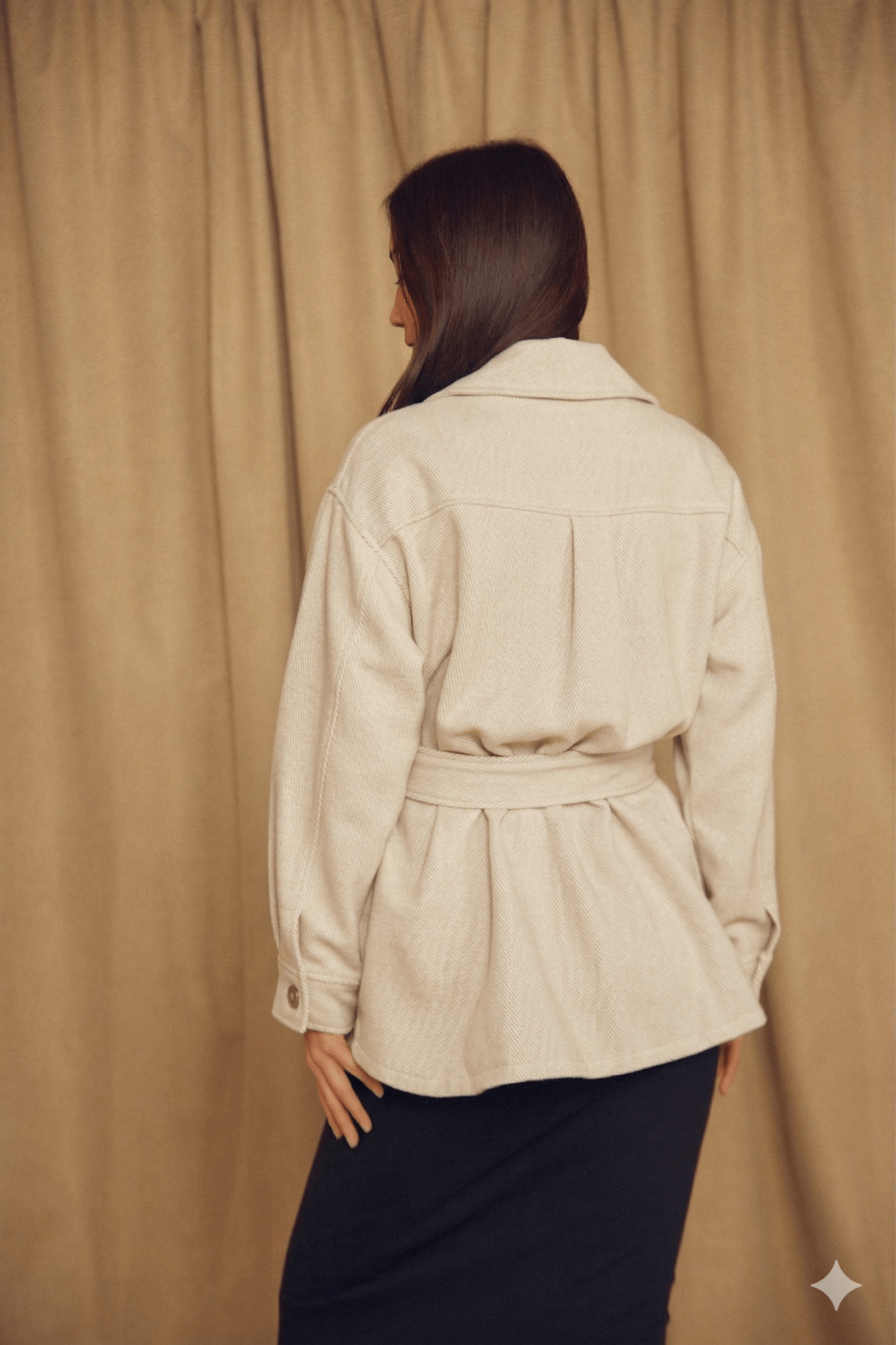 Model wearing the Ecru Organic Cotton Shacket from the back, showcasing its relaxed silhouette and detachable belt.