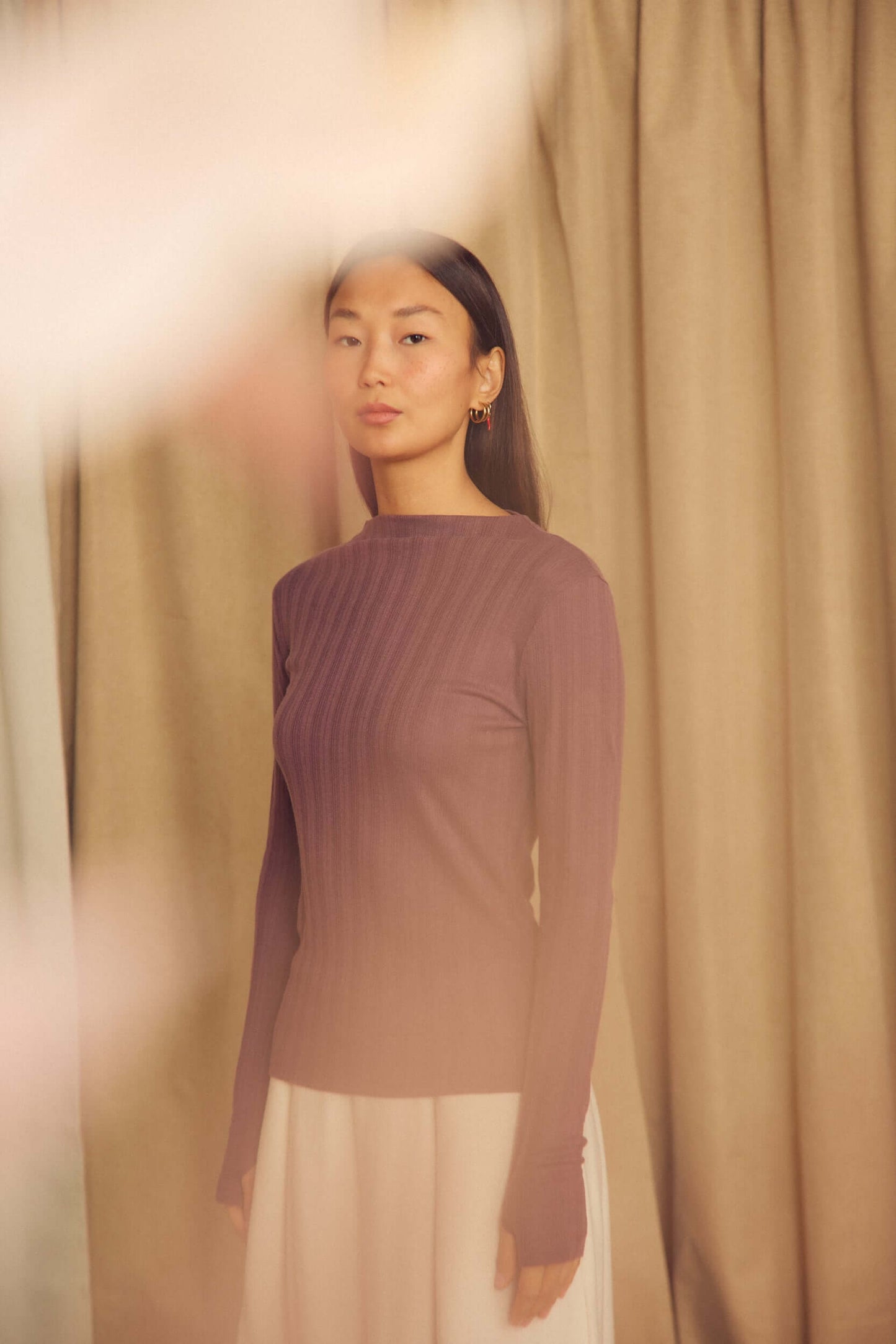 Cocoa Lyocell Ribbed Long Sleeve Top on a model against a light background showcasing its fine ribbed texture.