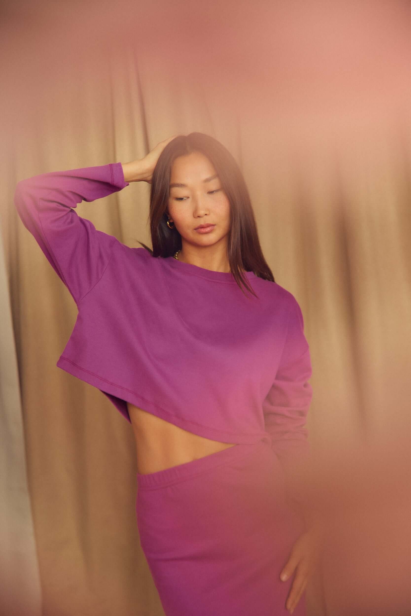 Model wearing a Plum Organic Cotton Pencil Midi Skirt paired with a matching top in a stylish pose.