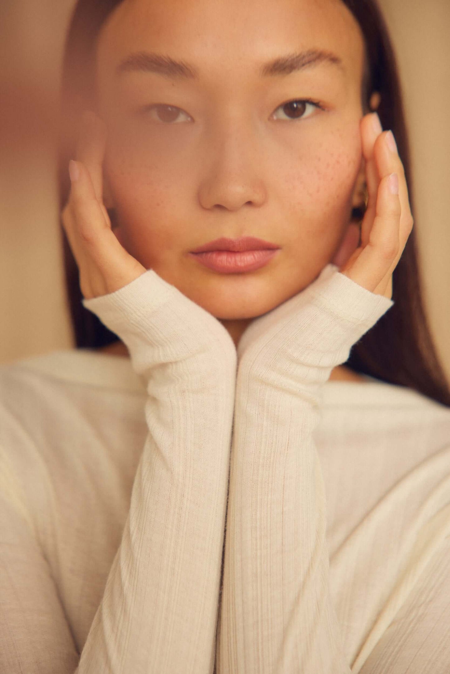 Ecru Lyocell Ribbed Long Sleeve Top worn by a model showcasing its soft, close-to-body fit and elevated design.