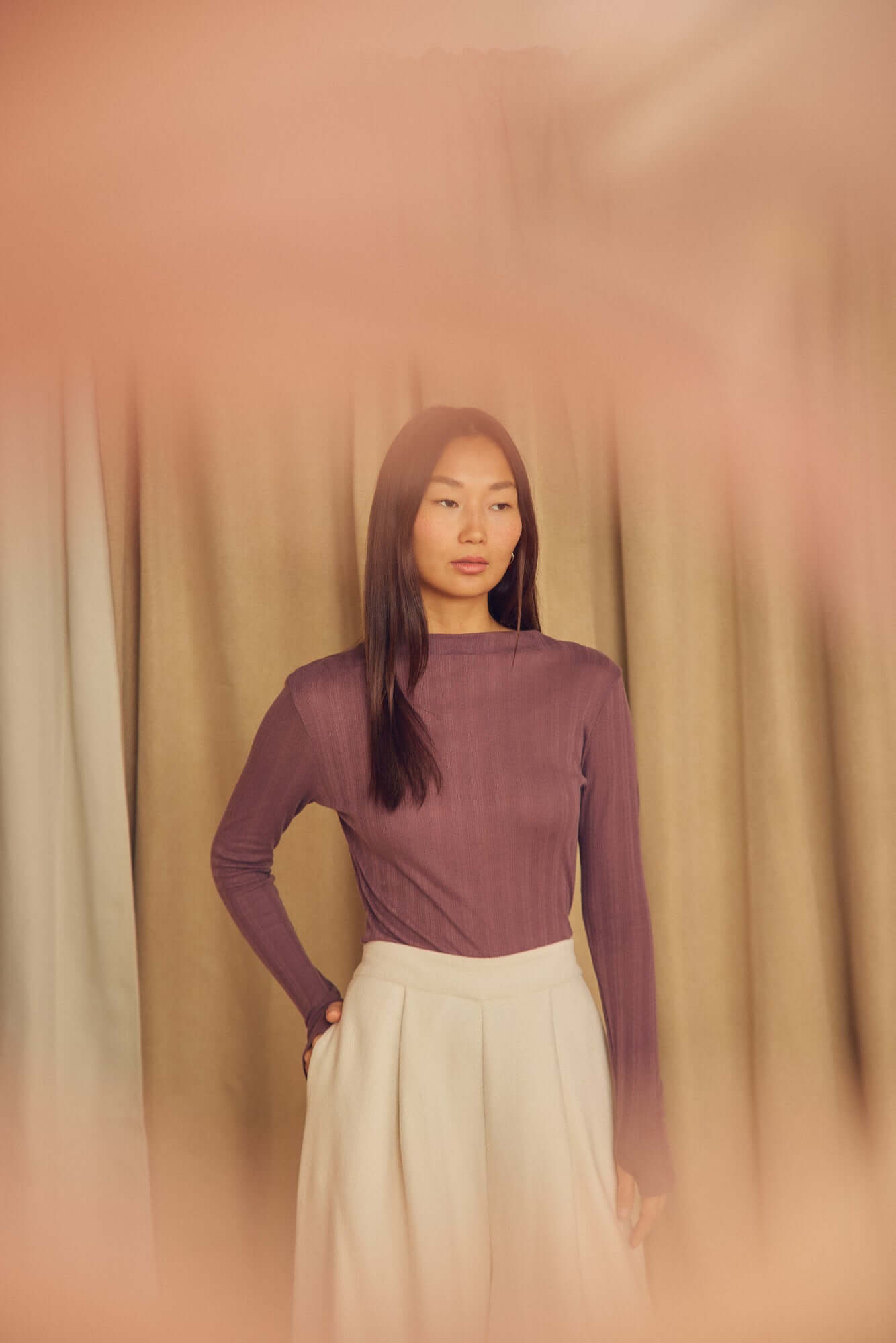 Cocoa Lyocell Ribbed Long Sleeve Top worn by a model, showcasing a refined, cocoa brown color with a soft fit.