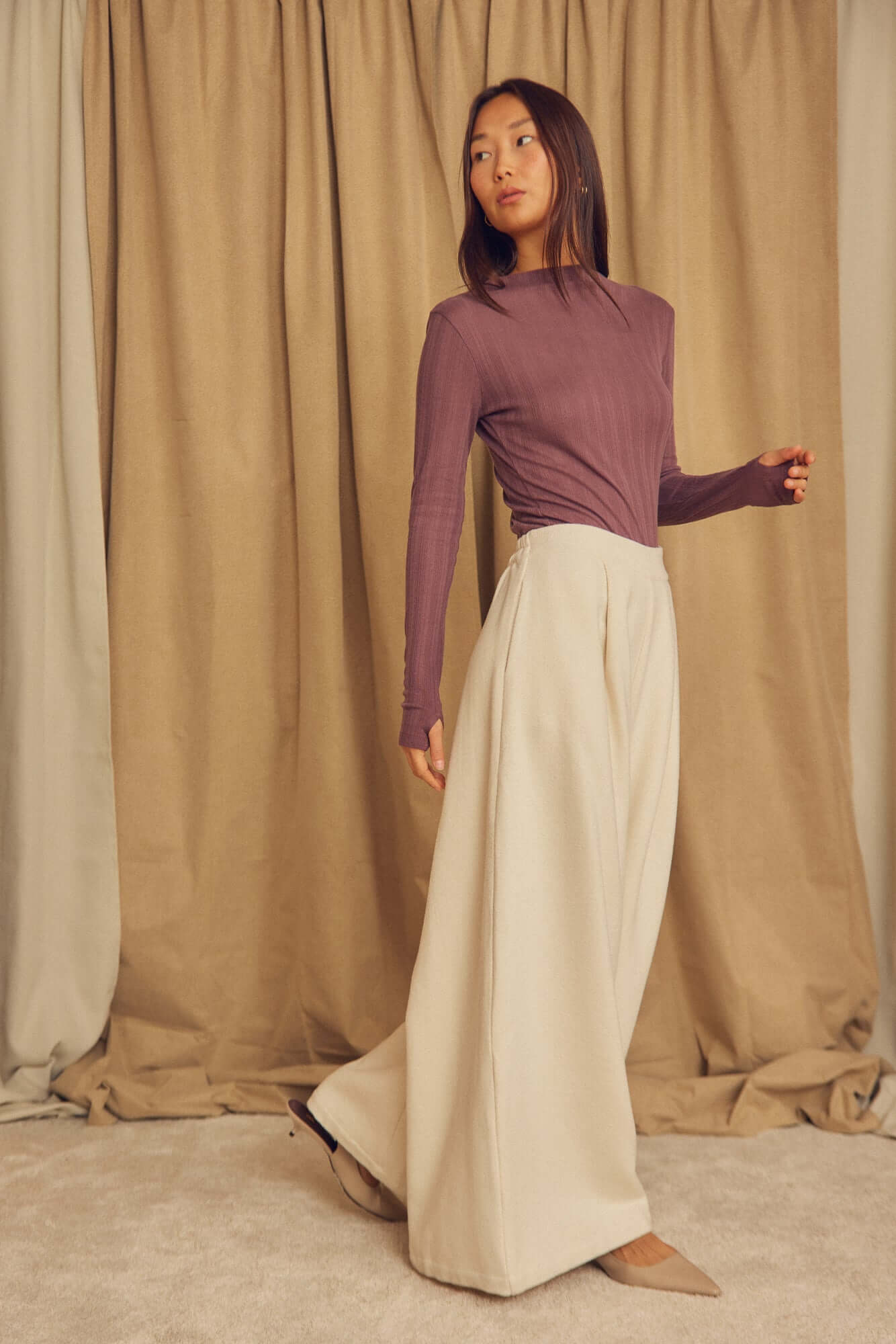 Model wearing Ecru Organic Cotton Wide Trousers with a fitted purple top, showcasing a stylish wide-leg silhouette.