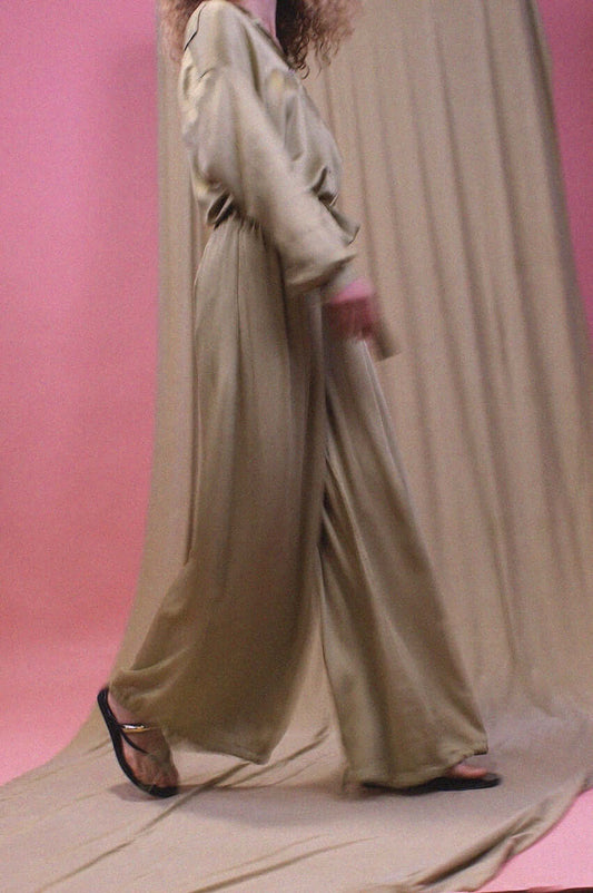Wide Ecovero Trousers in Soft Olive showcased on a model, highlighting their elegant drape and relaxed silhouette.