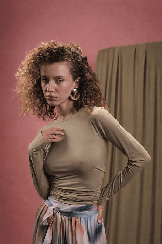 Model wearing the Cupro Multiway Wrap Top in Soft Olive, showcasing a versatile and elegant style.