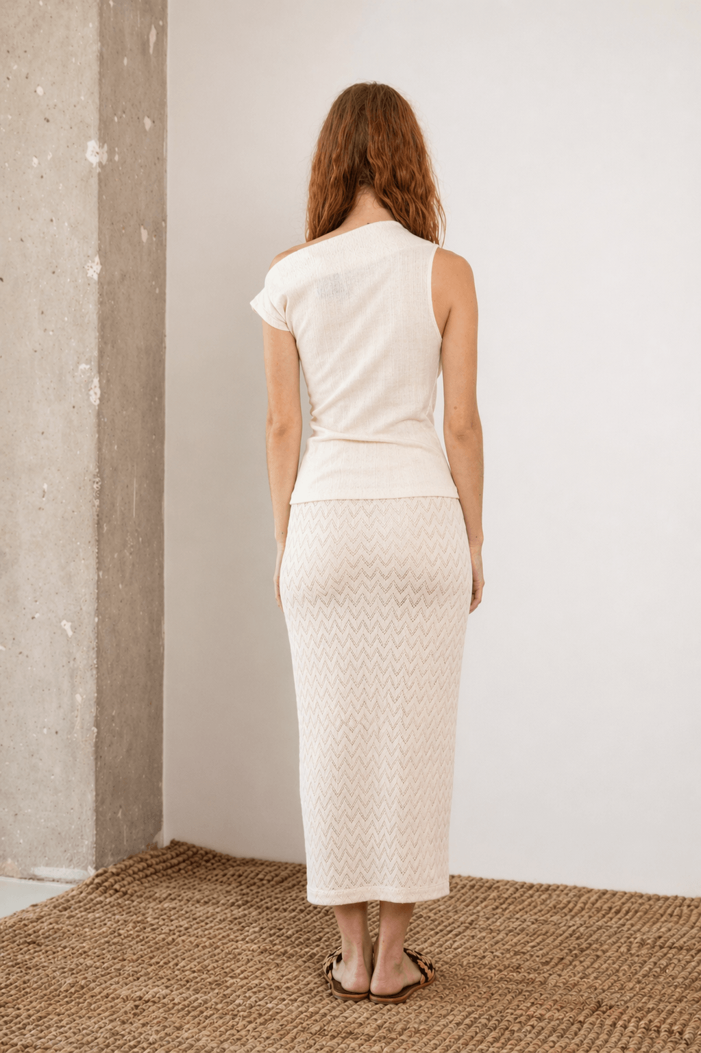 Back view of the Banana Pineapple Drape Neckline Top in Ecru paired with a matching skirt.