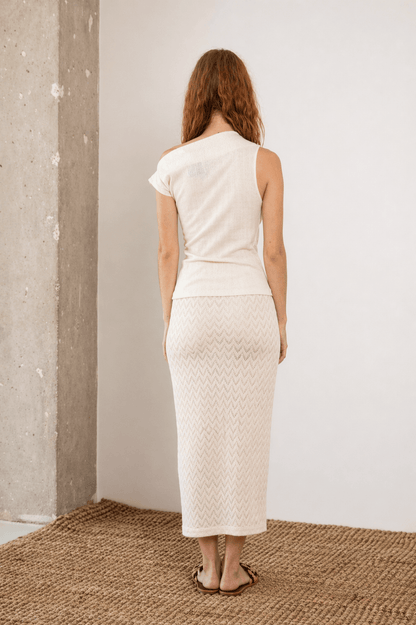 Back view of the Banana Pineapple Drape Neckline Top in Ecru paired with a matching skirt.