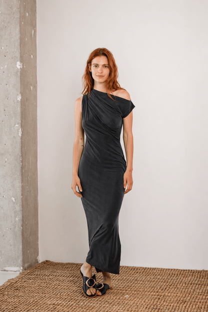 Drape Cupro Midi Dress in Slate Black worn by a model, showcasing a draped neckline and sleek silhouette.