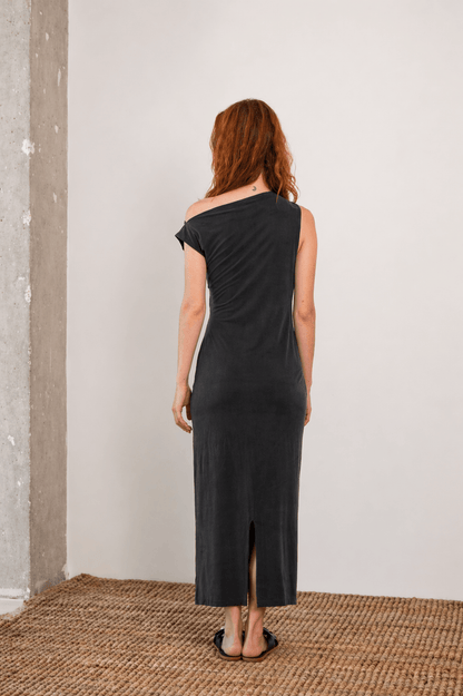 Back view of the Drape Cupro Midi Dress in Slate Black, showcasing its sleek fit and stylish slit.