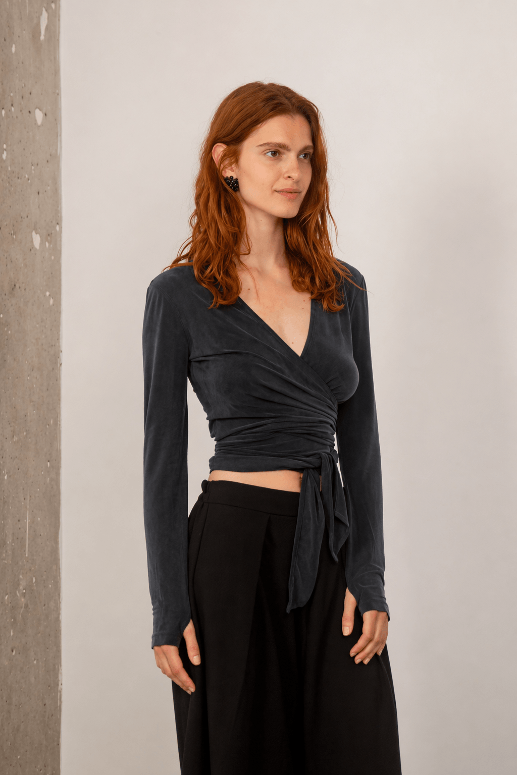 Cupro Multiway Wrap Top in Slate Black worn by a model, featuring a sleek wrap design and long sleeves.