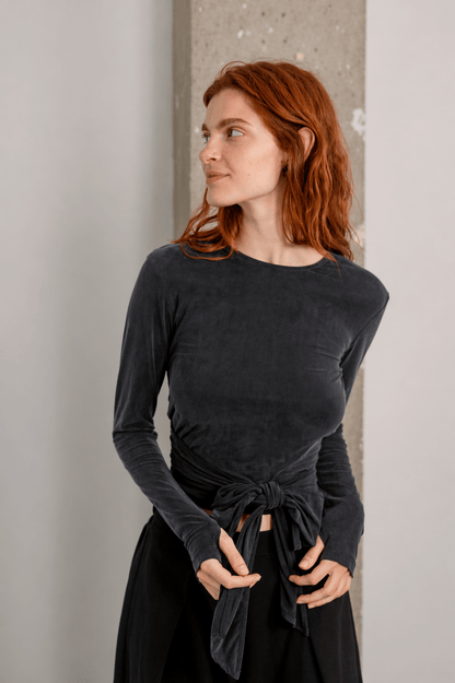 Cupro Multiway Wrap Top in Slate Black worn by a model with red hair, showcasing its versatile wrap design.