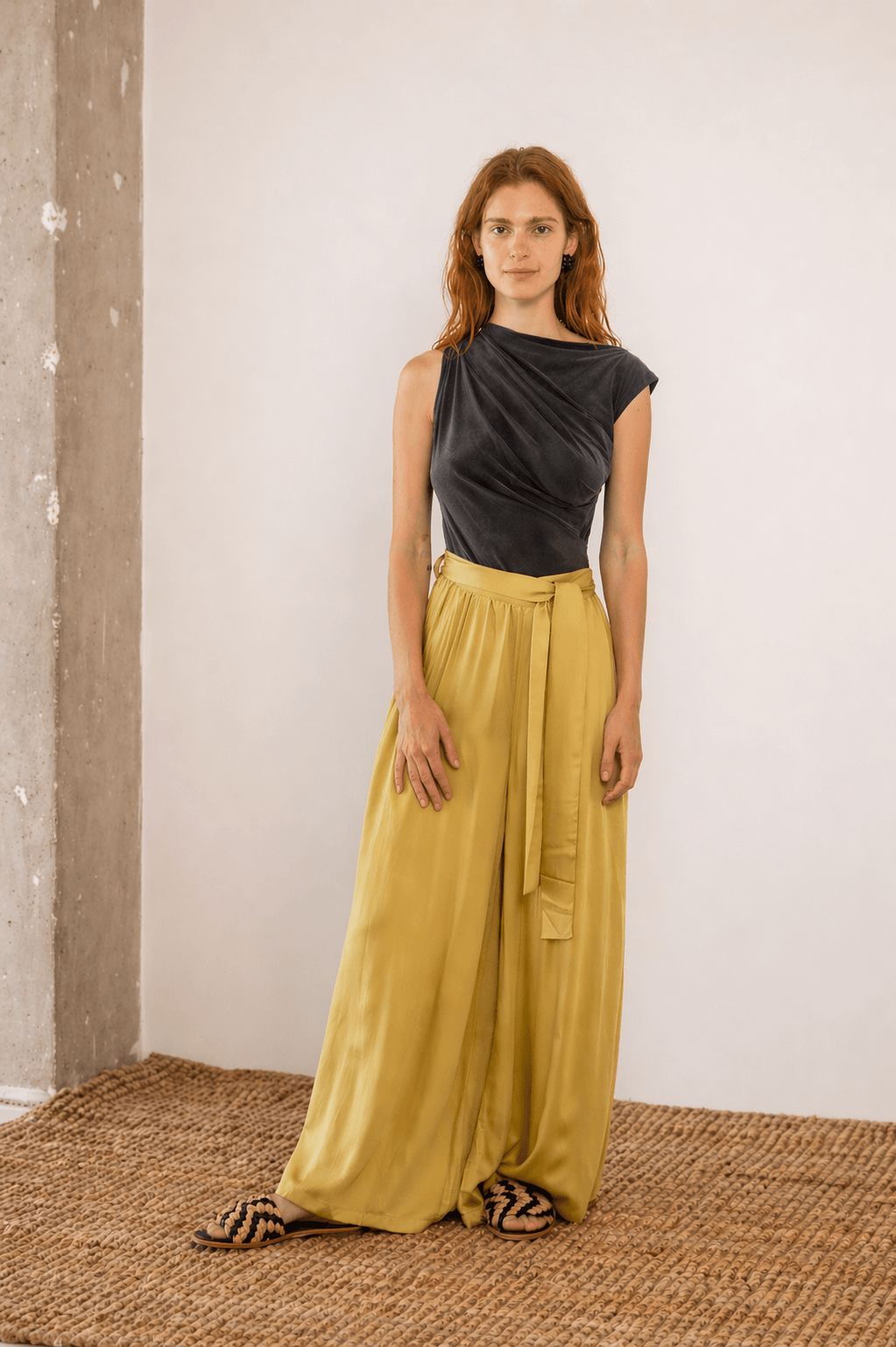 Drape Neckline Bodysuit in Slate Black paired with yellow wide-leg trousers, showcasing modern styling and comfortable fit.
