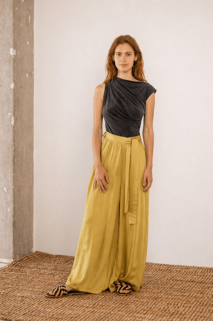 Drape Neckline Bodysuit in Slate Black paired with yellow wide-leg trousers, showcasing modern styling and comfortable fit.