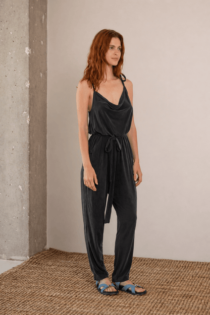 Cupro Slip Jumpsuit with Belt in Slate Black worn by model, showcasing relaxed elegance and versatility.