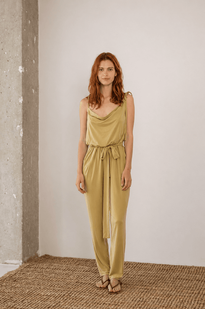 Cupro Slip Jumpsuit with Belt in Olive worn by a model, showcasing a modern and fluid design.