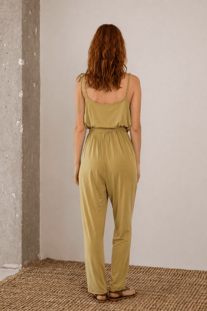 Model wearing Cupro Slip Jumpsuit with Belt in Olive, showcasing the relaxed back design and fluid fit.