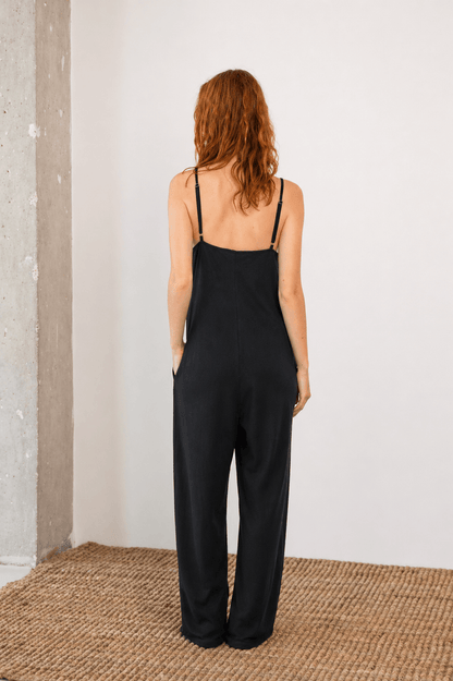 Organic Cotton Wide Jumpsuit in Black, back view showcasing slim straps and relaxed fit.