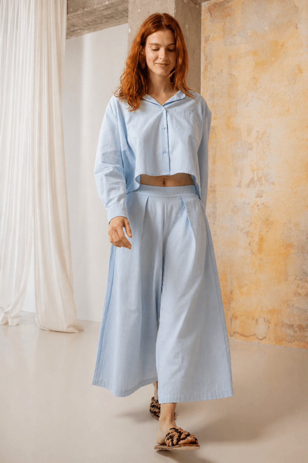 Model wearing Organic Cotton Wide Culottes in Pale Blue with a matching shirt, showcasing relaxed spring style.