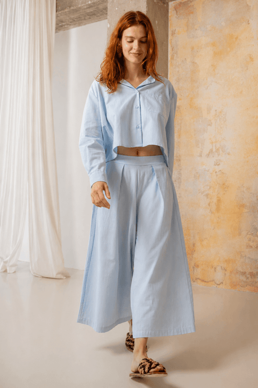 Model wearing Organic Cotton Wide Culottes in Pale Blue with a matching shirt, showcasing relaxed spring style.