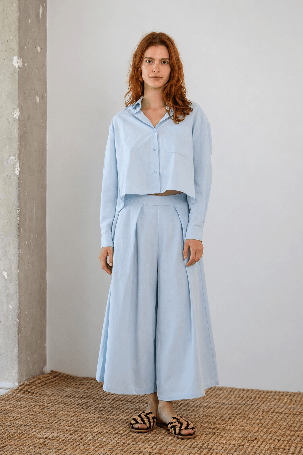 Model wearing Organic Cotton Wide Culottes in Pale Blue with a matching cropped shirt for a stylish summer look.