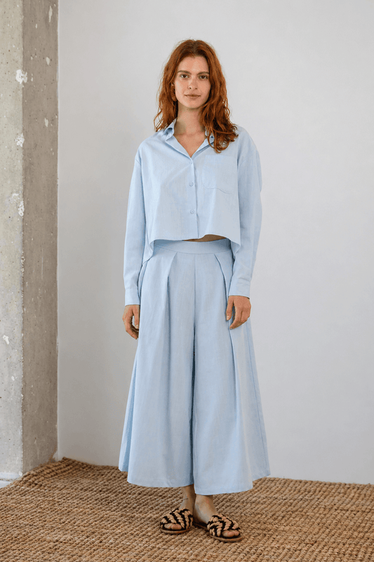 Model wearing Organic Cotton Wide Culottes in Pale Blue with a matching cropped shirt for a stylish summer look.