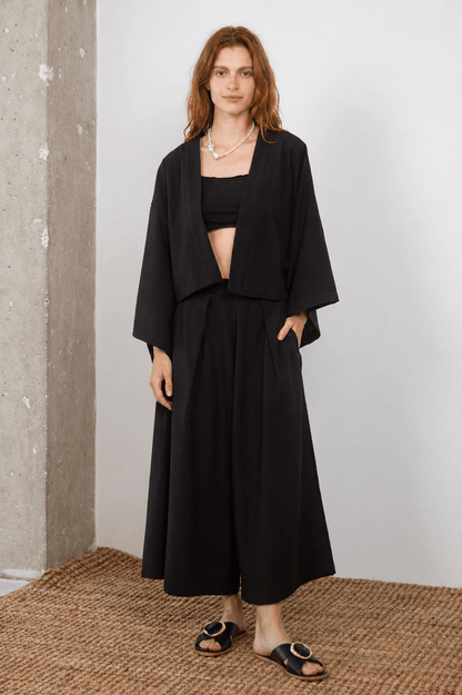 Model showcasing Organic Cotton Wide Culottes in Black with matching top, perfect for modern spring-summer styling.