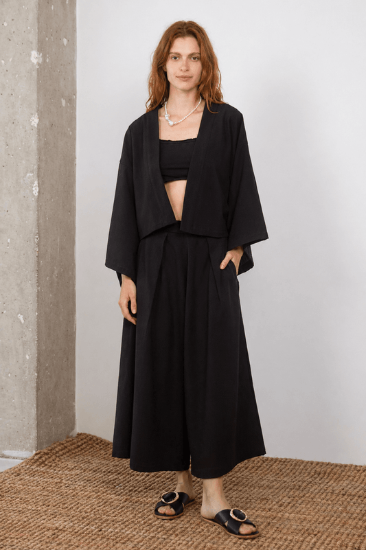 Model showcasing Organic Cotton Wide Culottes in Black with matching top, perfect for modern spring-summer styling.