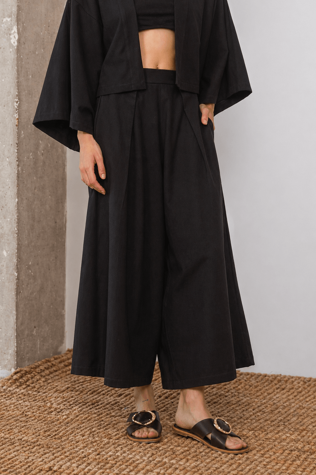 Organic Cotton Wide Culottes in Black worn with a crop top and sandals, showcasing a relaxed silhouette and modern style.