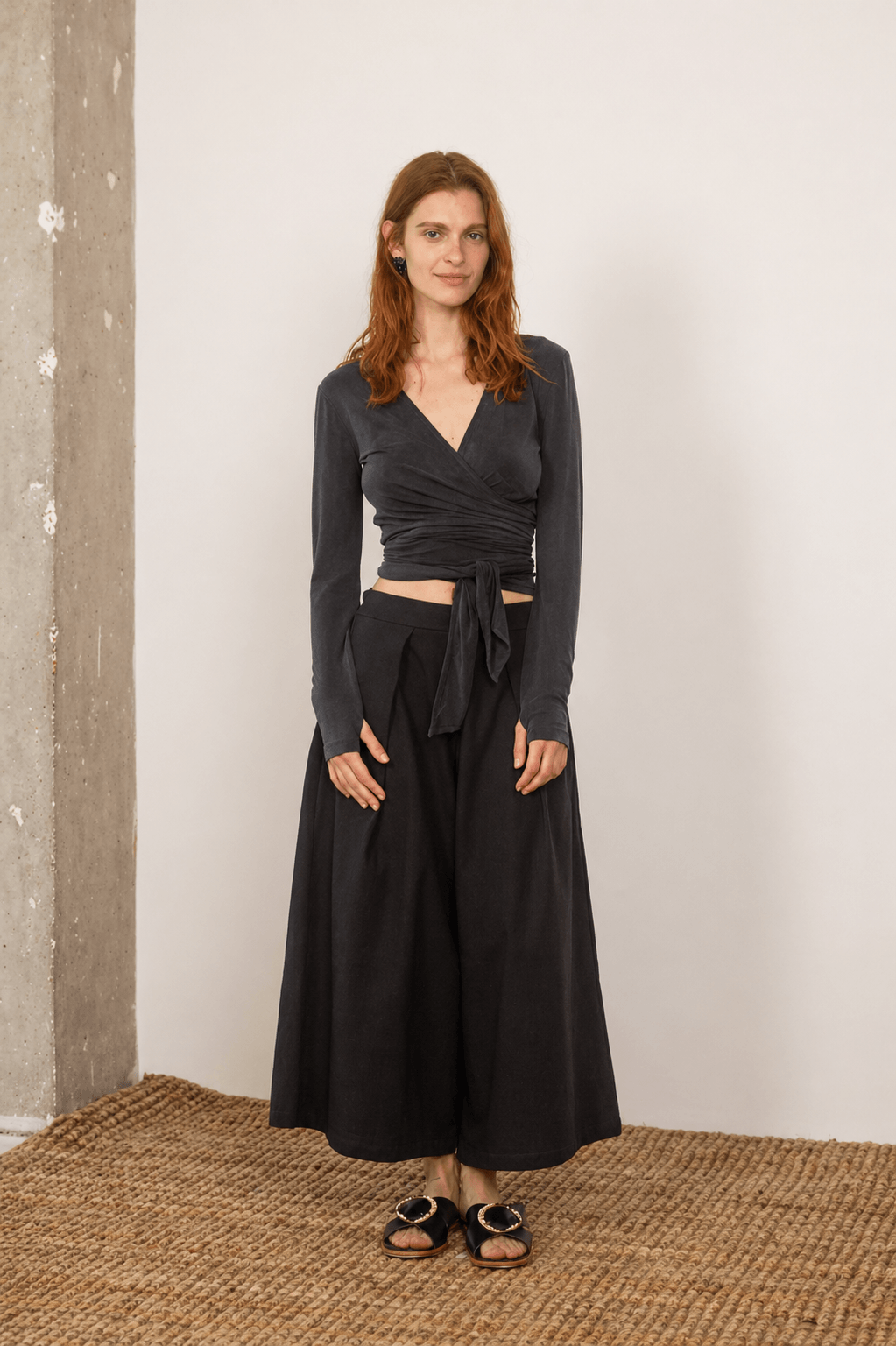 Model wearing Organic Cotton Wide Culottes in Black paired with a stylish long-sleeve top, showcasing effortless modern dressing.