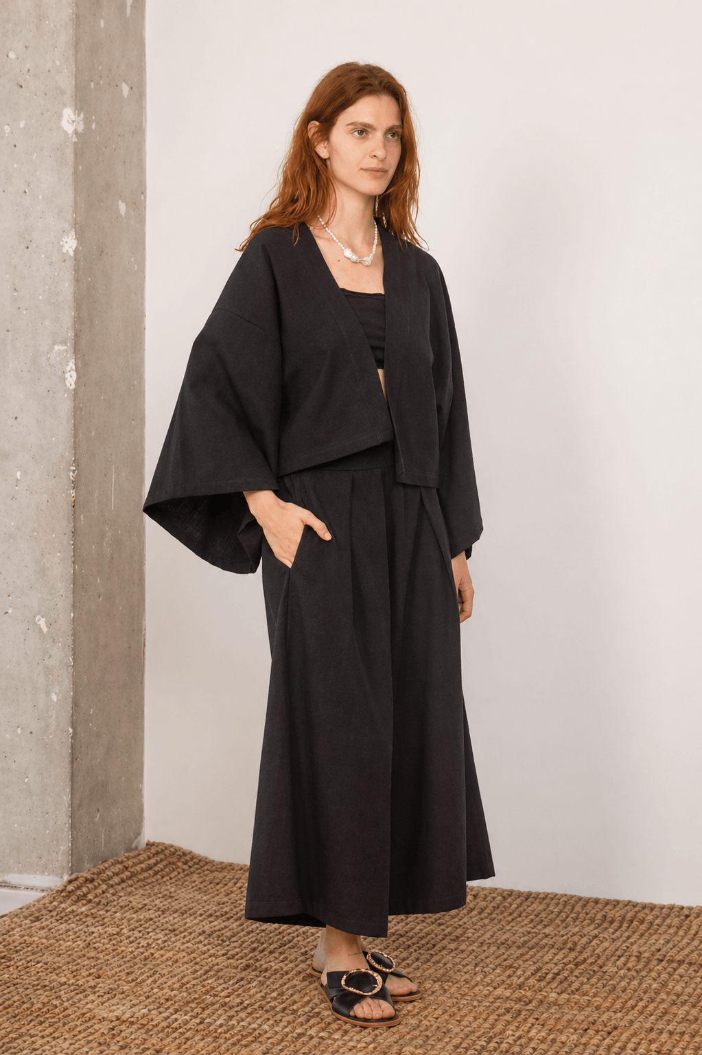 Organic Cotton Wide Culottes in Black displayed on a model, showcasing relaxed silhouette and modern styling.