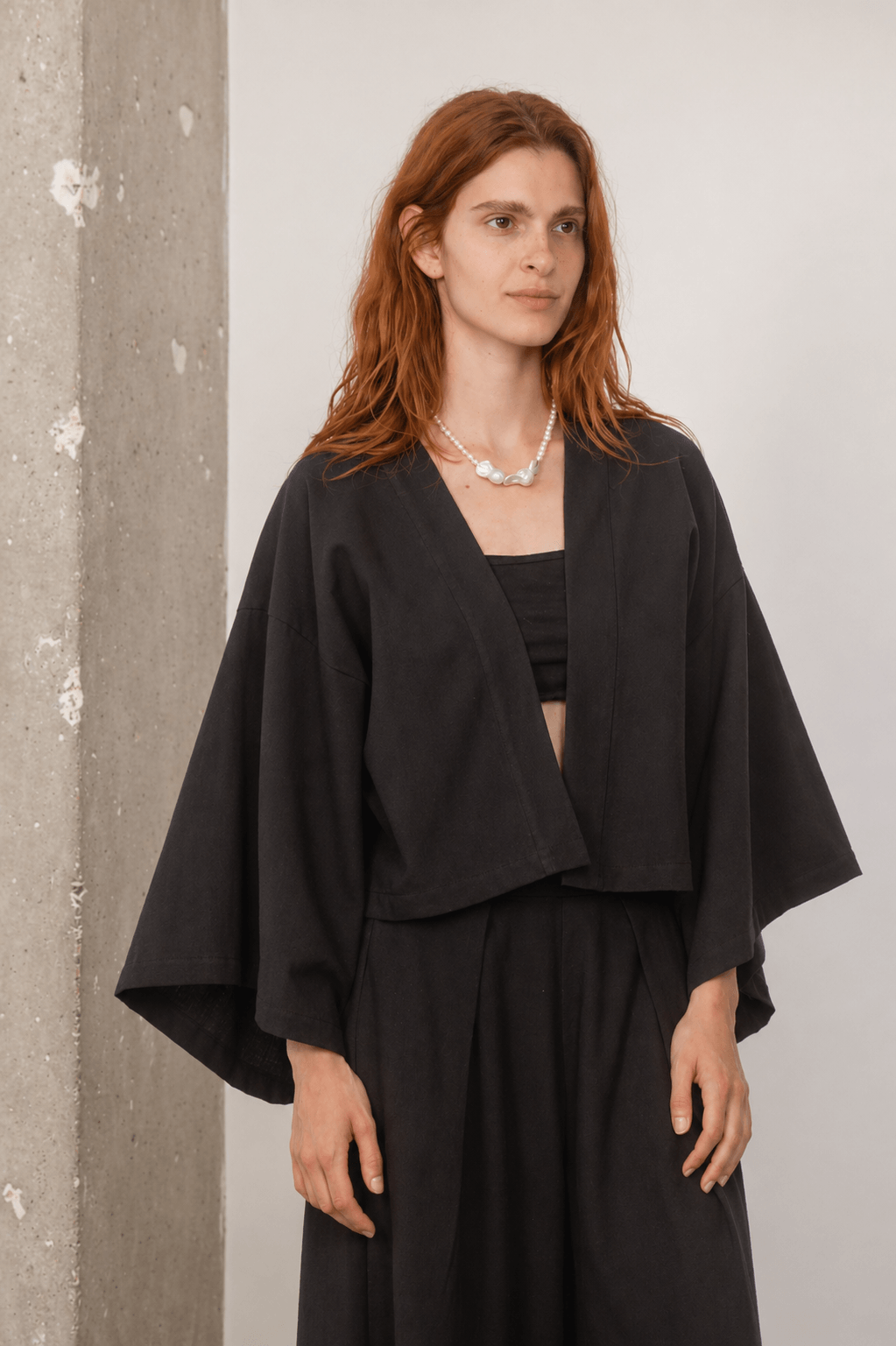 Model wearing Organic Cotton Kimono Jacket in Black, showcasing a relaxed silhouette and breathable comfort.