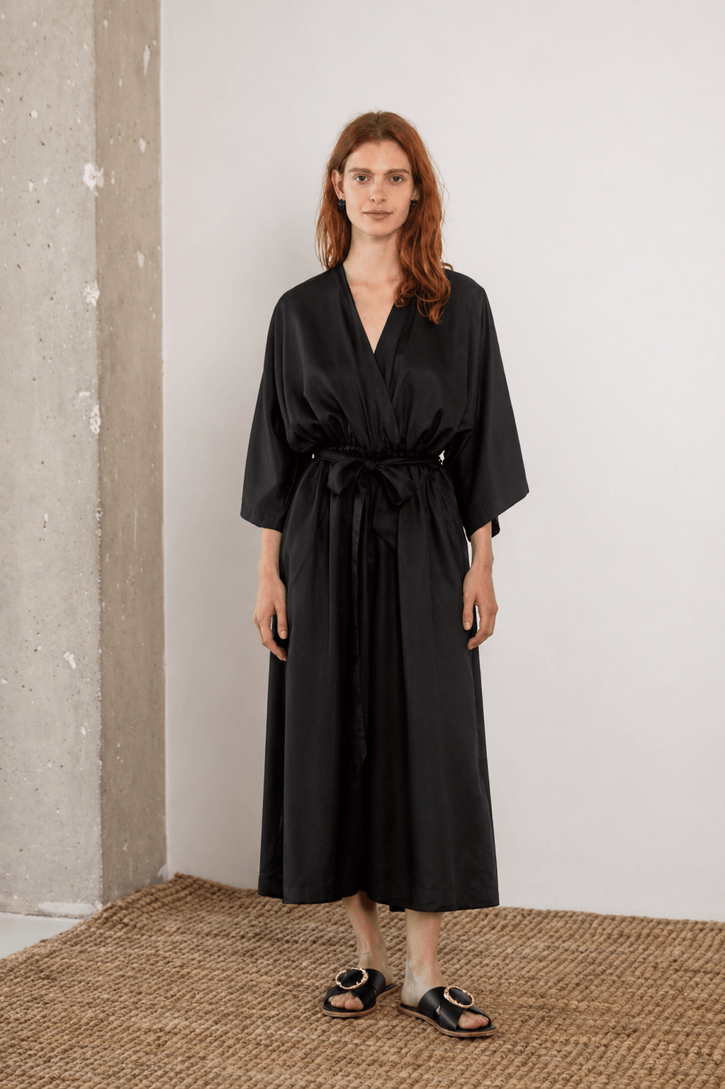 Tencel Kimono Jumpsuit in Black worn by model, showcasing relaxed silhouette and culotte-style trousers.