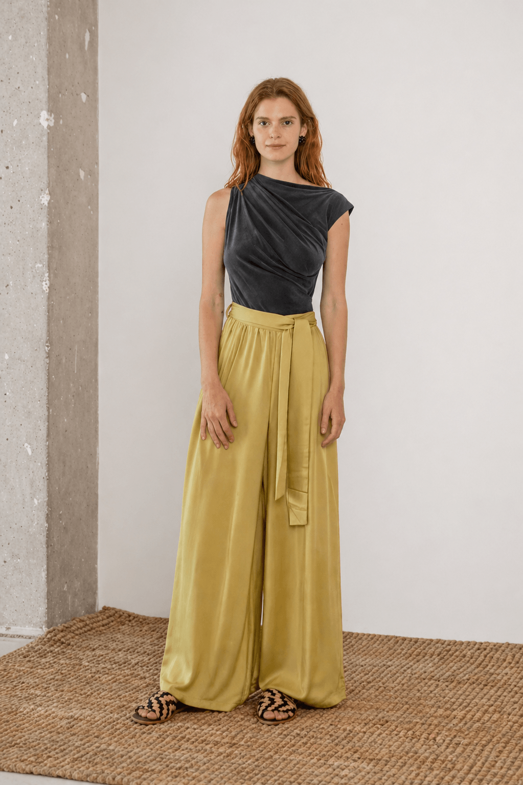 Wide Ecovero Trousers in Soft Olive paired with a stylish top, showcasing a relaxed oversized silhouette.