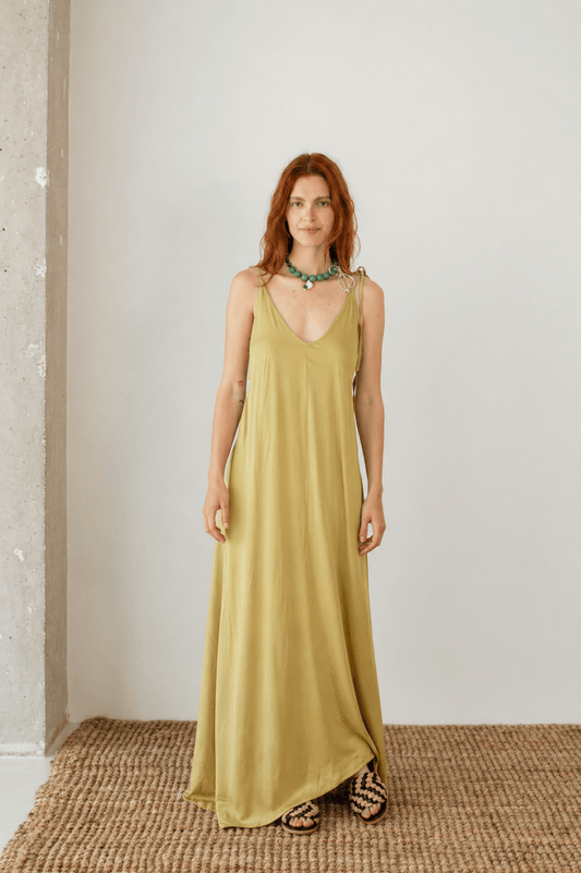 Ecovero Maxi Dress in Soft Olive worn by a model, showcasing its fluid design and adjustable straps.