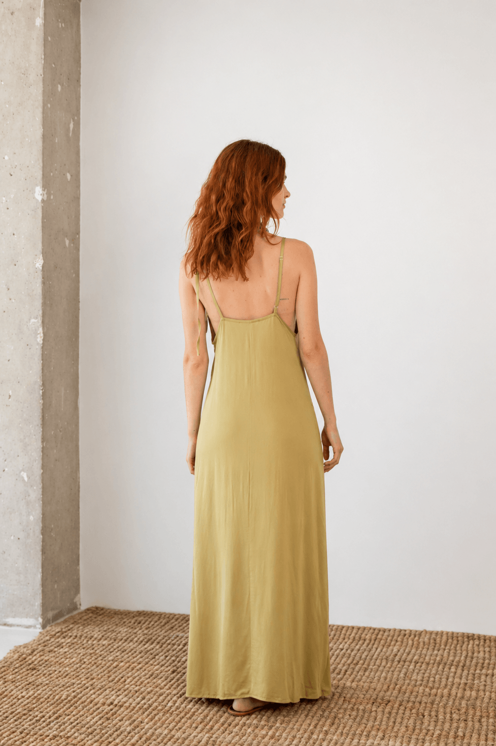 Ecovero Maxi Dress in Soft Olive, showcasing back view with adjustable straps and flowing fabric.