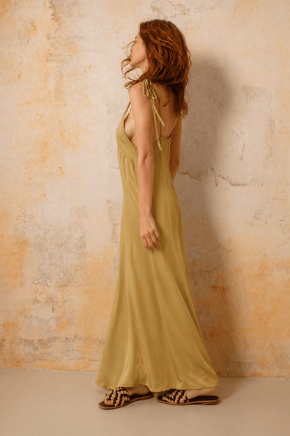 Ecovero Maxi Dress in Soft Olive showcased on a model from the side, highlighting its flowy design and adjustable straps.