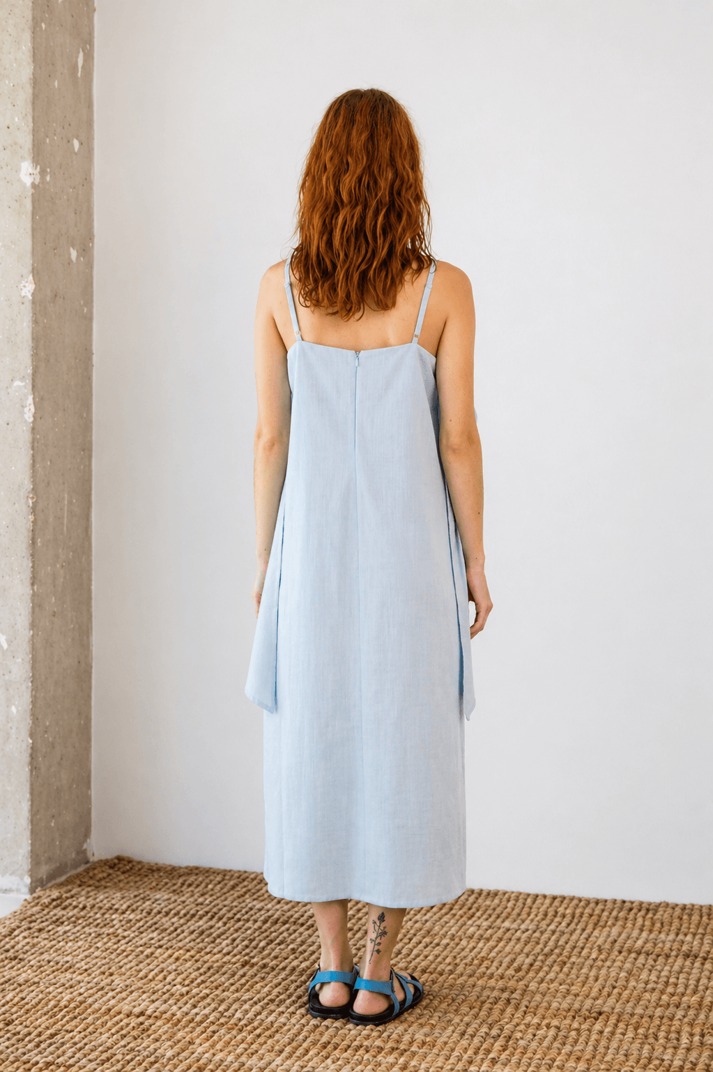 Organic Cotton Sun Dress with Front Frill in Pale Blue - back view showcasing relaxed silhouette and soft fabric.