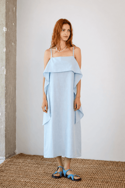 Organic Cotton Sun Dress with Front Frill in Pale Blue worn by a model, showcasing a relaxed silhouette and frill detail.