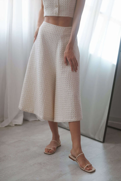 Ecru waffle skirt culottes with a high waist, side pockets, and a stylish A-line silhouette, perfect for versatile outfits.