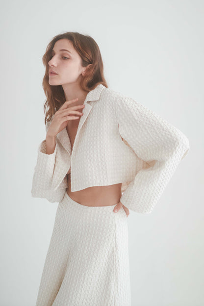 ECRU WAFFLE CROP JACKET worn by a model, showcasing its lightweight and stylish design.