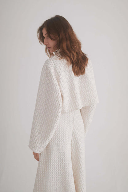 ECRU WAFFLE CROP JACKET featuring a model showcasing the lightweight design and waffle texture from the back.