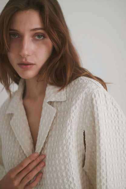 ECRU WAFFLE CROP JACKET shown on a model featuring lightweight waffle woven fabric in a soft color.