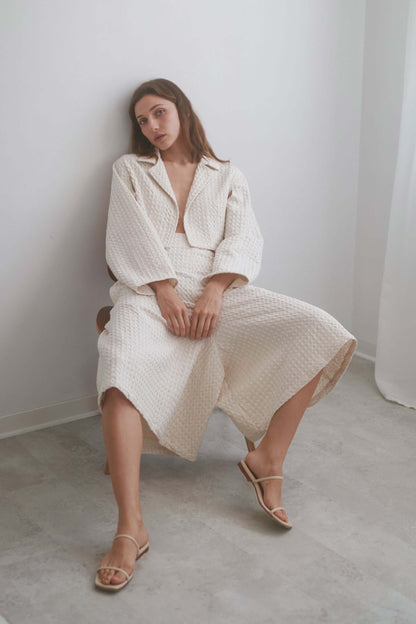 Model wearing ECRU WAFFLE CROP JACKET paired with waffle culottes, showcasing stylish summer layering.