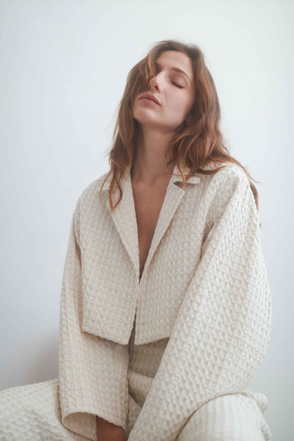 Model wearing ECRU WAFFLE CROP JACKET showcasing its lightweight design and breathable fabric.