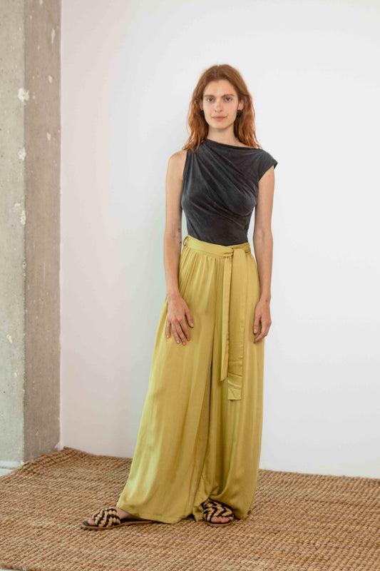 Drape Neckline Cupro Top in Black worn with flowing olive trousers, showcasing elegant summer styling.