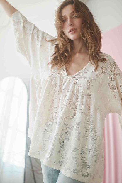 Boho-inspired lace tunic top in ecru with V-neckline and wide short sleeves, made from organic cotton.