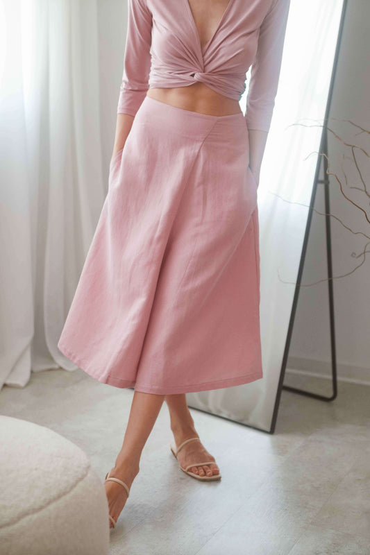 Elegantly styled rose culottes paired with a matching wrap top, showcasing a high waist and practical side pockets.