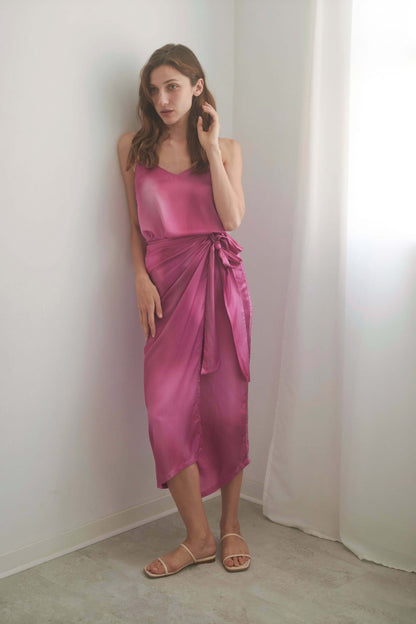 Model wearing a pink PRINT WRAP MIDI SKIRT with self-tie closure, showcasing the luxurious Ecovero viscose fabric.
