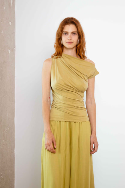 Drape Neckline Cupro Top in Black displayed on a model wearing a soft olive color, showcasing its elegant draped design.
