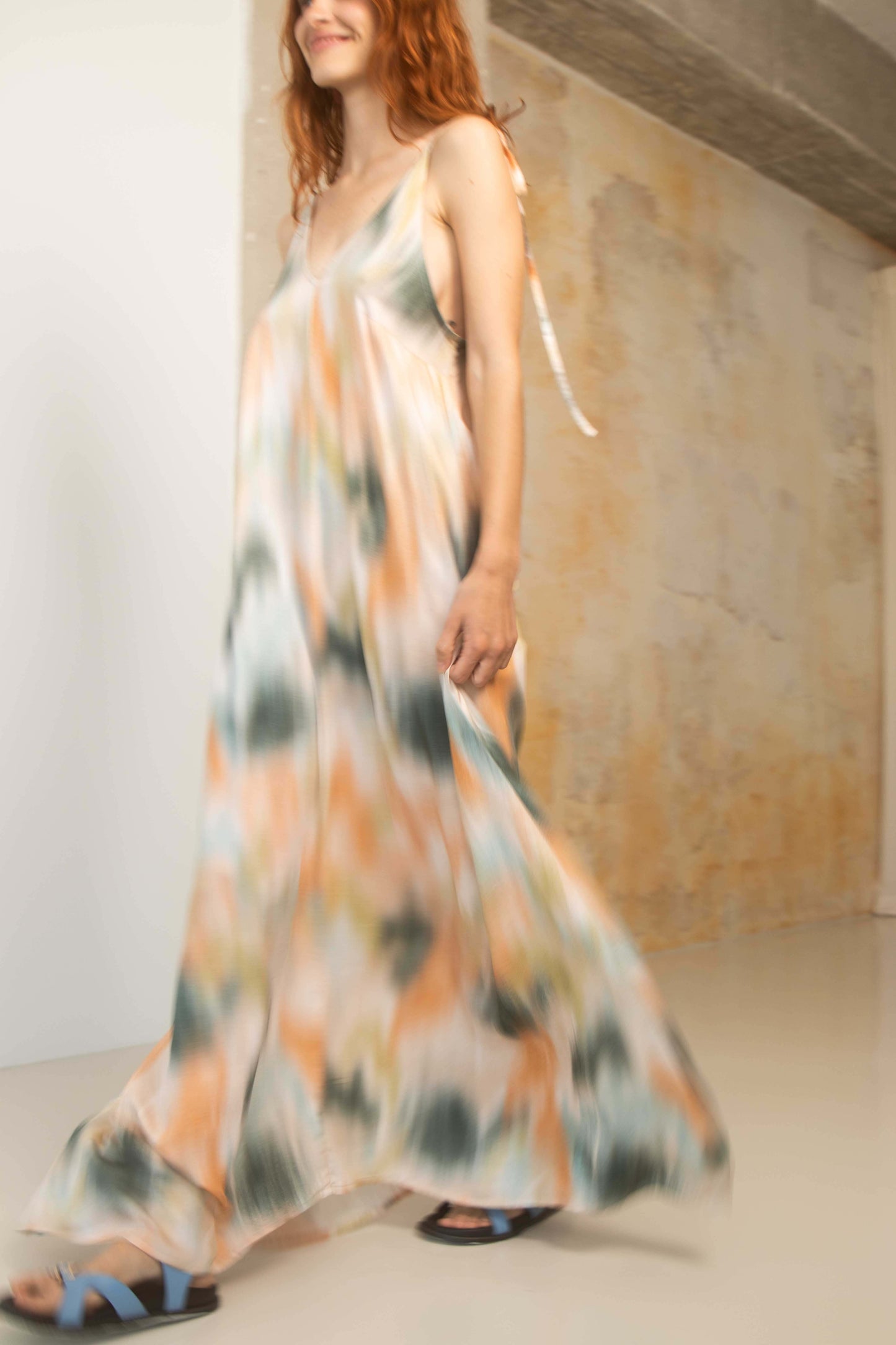 Model wearing a Printed Ecovero Viscose Maxi Dress, showcasing its fluid design and colorful print.